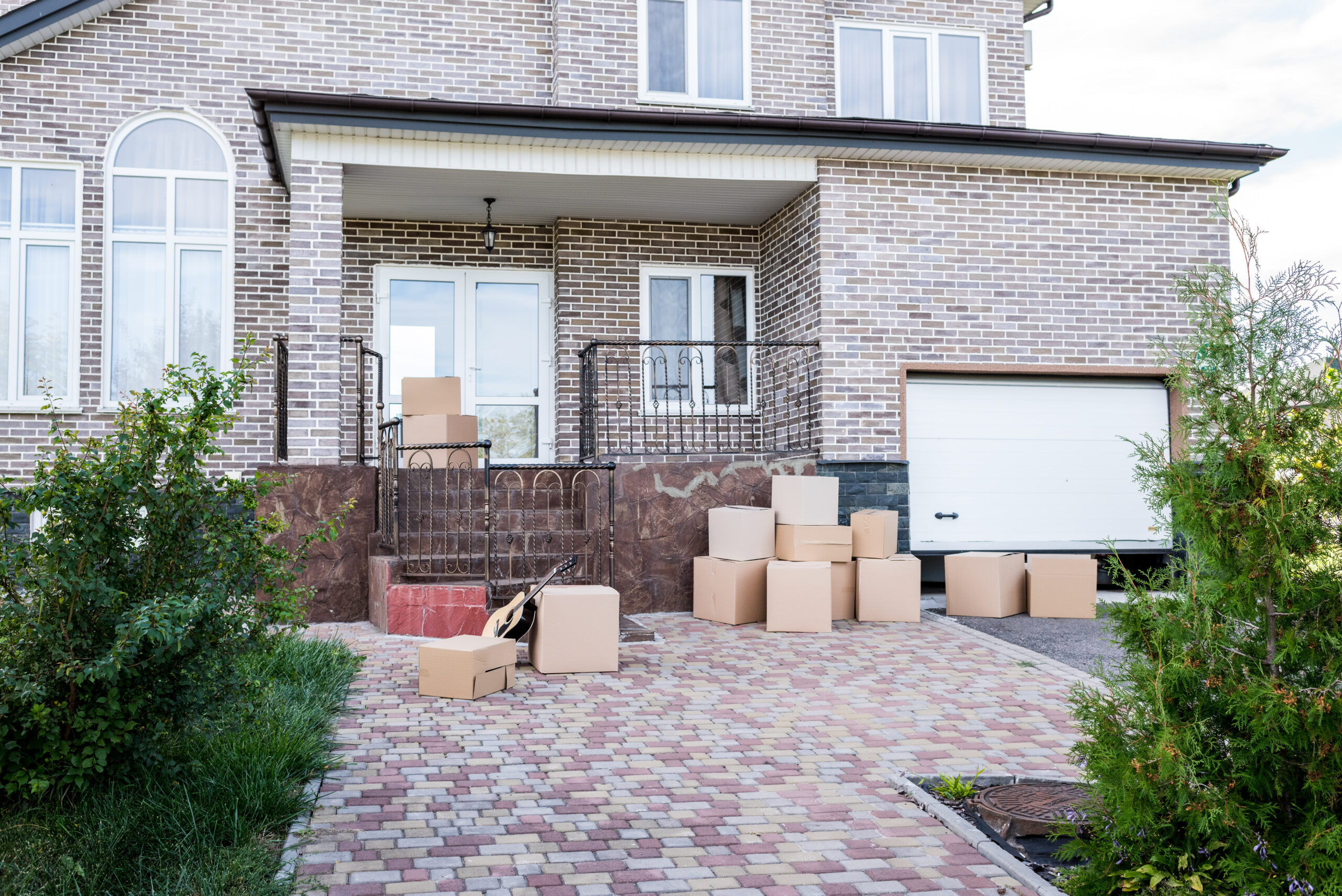 modern house with stacks of cardboard boxes for moving